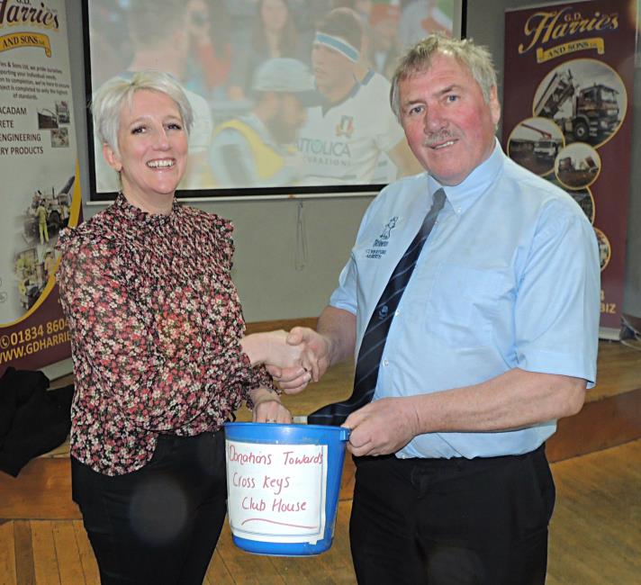 Narberth chairman Dorian Phillips presents the collection cash to Cross Keys Sophie Wilkins